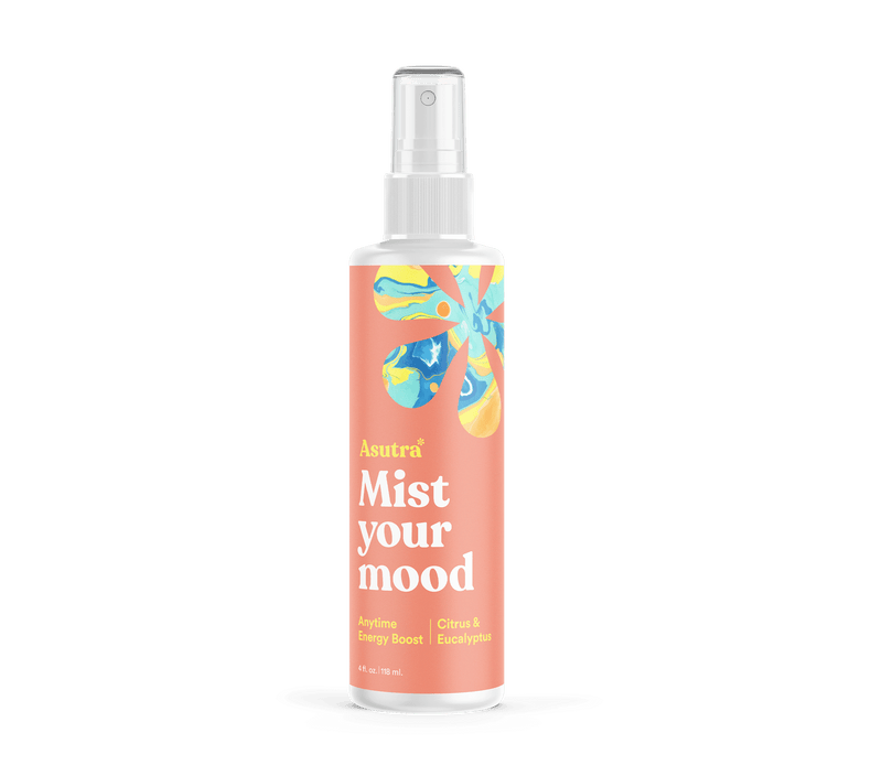 A white spray bottle of Anytime Energy Boost Aromatherapy Mist with colorful abstract floral design and label reading "Mist your mood.