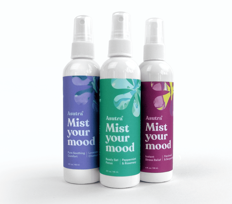 Three bottles of Asutra Aromatherapy Mist 3 Pack with colorful labels for mood, focus, and stress relief.