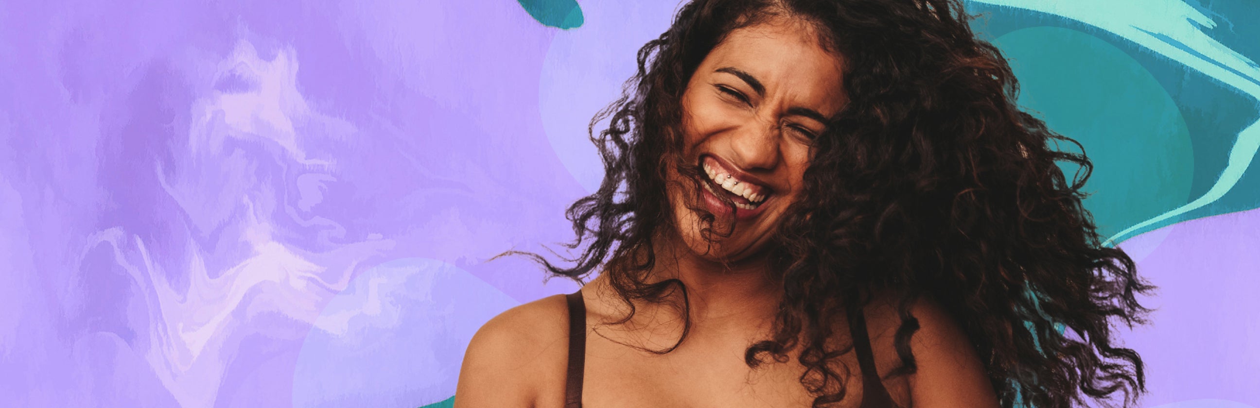 Joyful woman laughing and smiling with marble purple background.