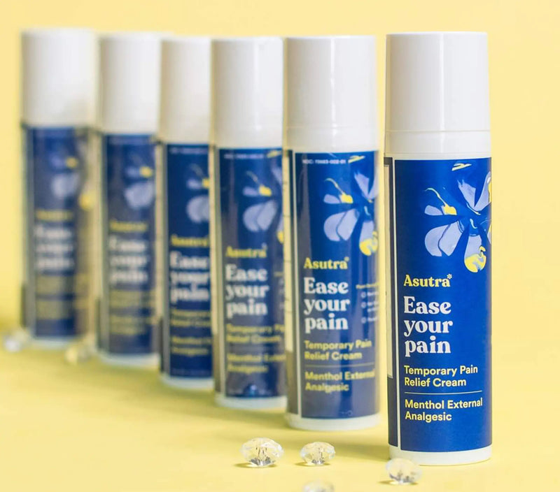Six bottles of Asutra Menthol & Arnica Pain Relief Gel with white caps, blue labels, and yellow text, arranged in a row on a yellow background.