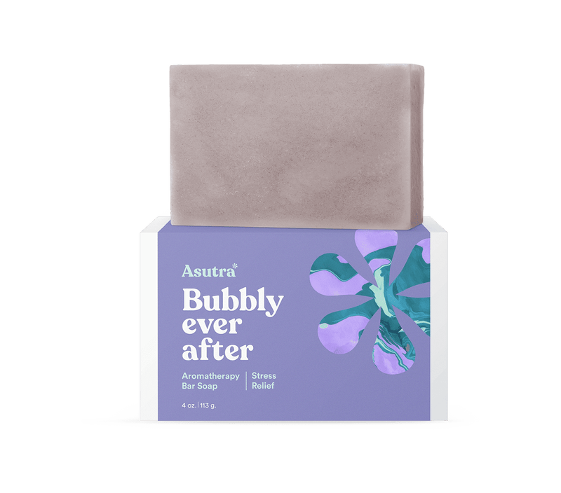 A lavender-colored bar soap labeled "Asutra Bubbly Ever After" on a purple and white box, designed for stress relief and aromatherapy.