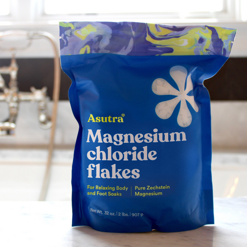 Asutra Magnesium Chloride Flakes package for relaxing body and foot soaks, featuring a vibrant blue design.