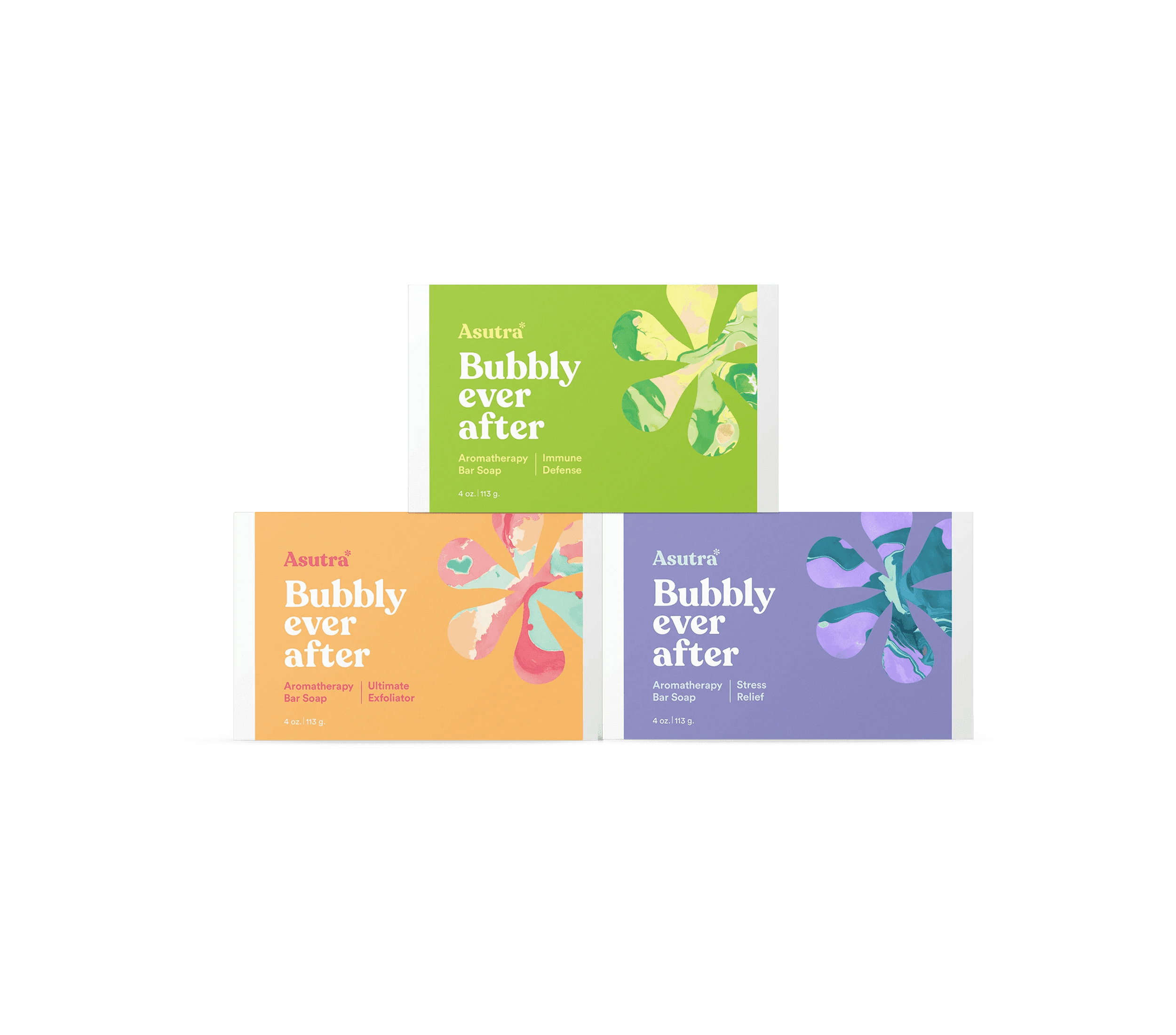 Three Asutra Bubbly Ever After aromatherapy bar soap packages in green, orange, and purple, each with colorful floral designs.
