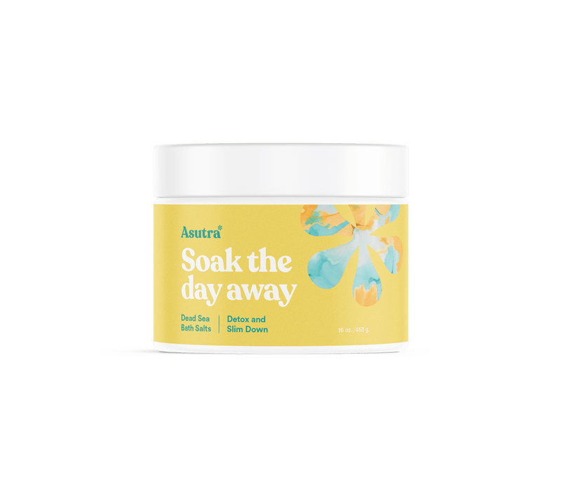 Container of Asutra Detox & Slim Down Bath Salts with a yellow label, floral design, and white lid, promoting relaxation and detoxification.