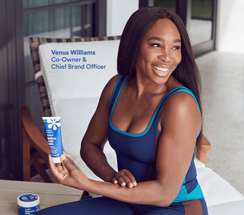 Smiling woman in athletic wear holding the Ultimate Pain Relief Bundle, including Relieve and Melt Pain capsules, on a porch.