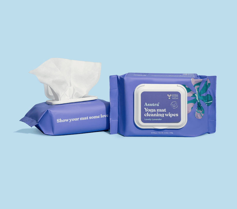Lavender yoga mat cleaning wipes in a blue pouch with a white lid, featuring a tissue dispenser and floral design.