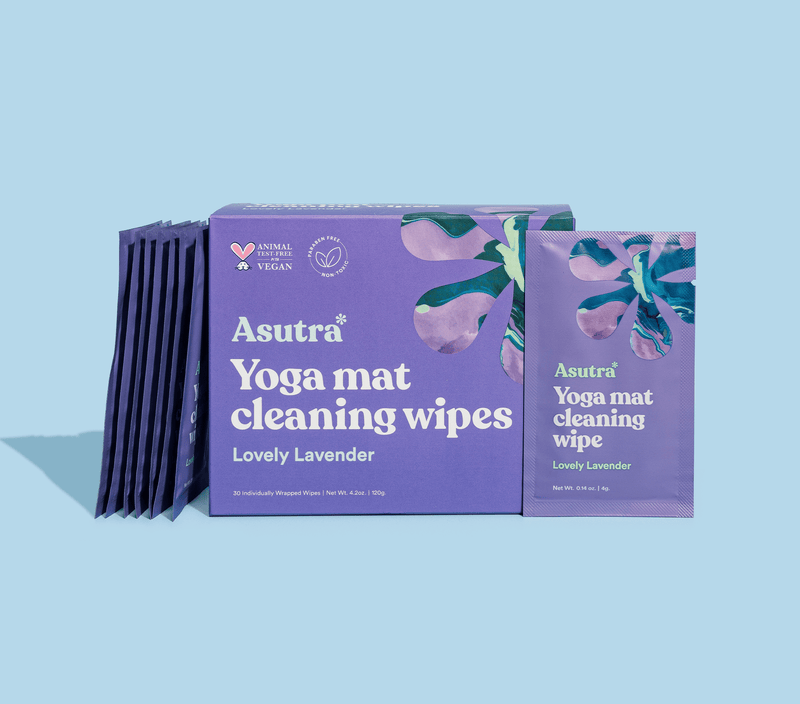 Box of lavender-scented yoga mat cleaning wipes with individual sachets, featuring purple packaging and floral design.
