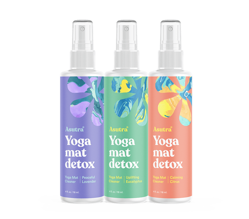 Set of three Asutra Yoga Mat Cleaner spray bottles with colorful labels, designed for cleaning and detoxifying yoga mats.
