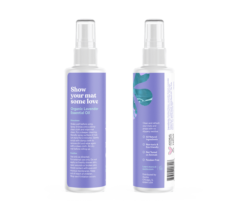 A white spray bottle labeled "Peaceful Lavender Yoga Mat Cleaner" with a purple and lavender design, featuring directions and ingredients.