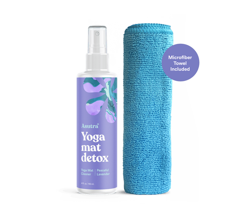 Spray bottle of Peaceful Lavender Yoga Mat Cleaner with microfiber towel, designed for cleaning and detoxing yoga mats.