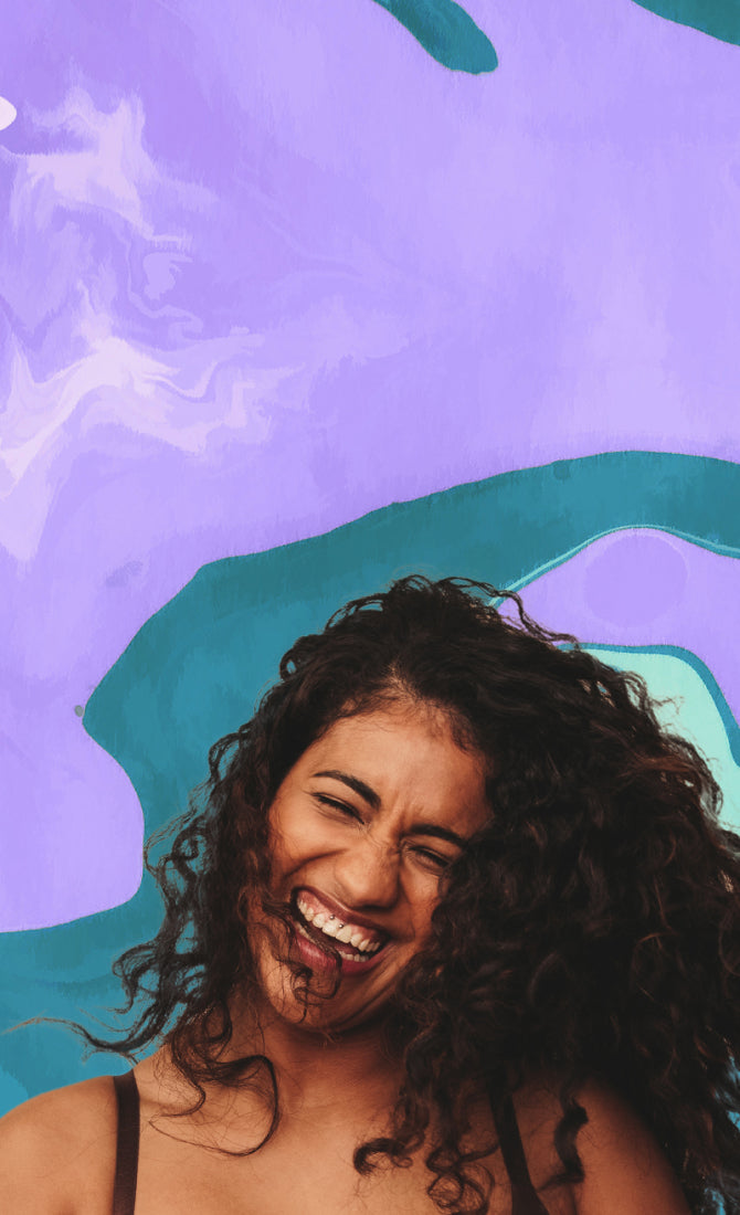 Joyful woman laughing and smiling with marble purple background.